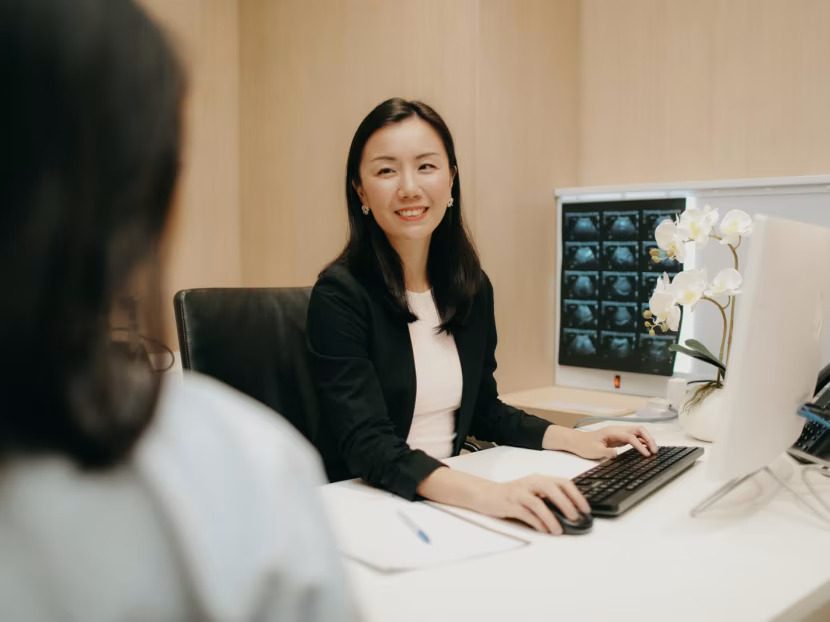 An AARO oncologist reviewing notes at their desk.