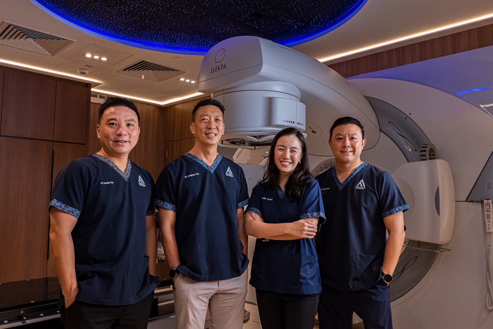 The four AARO radiation oncologists together at the Elekta linear accelerator in the Centre for Stereotactic Radiosurgery.