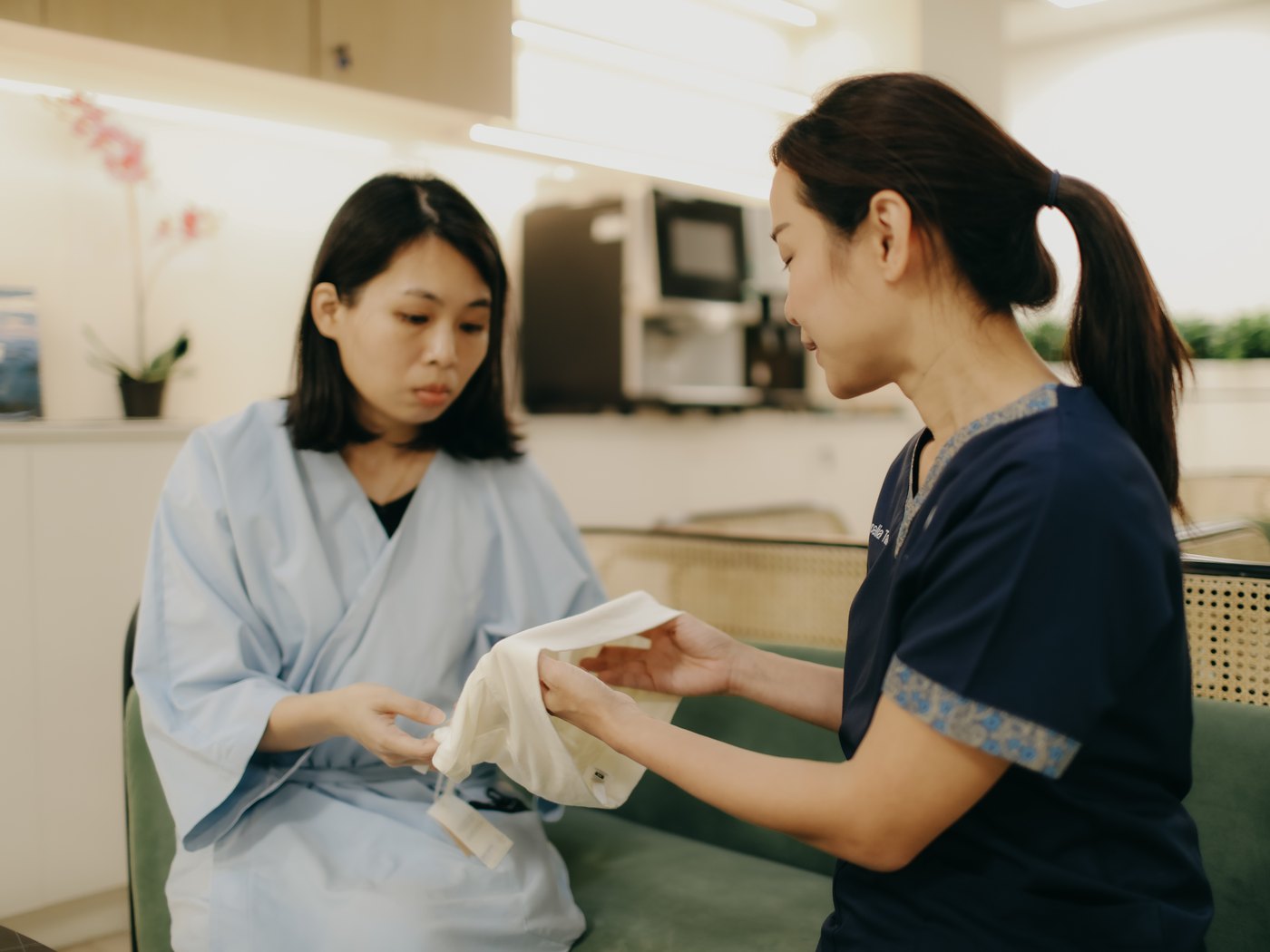 A care coordinator explaining insurance cover to a patient in the AARO lounge.